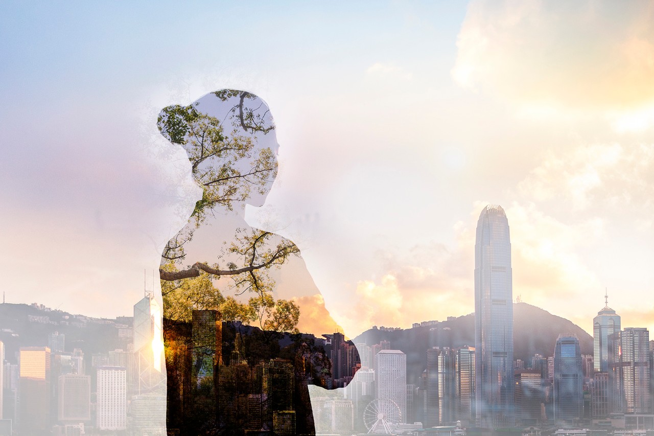 Asian woman skyscrapers Person standing in contemplation in urban Hong Kong city reflection with nature trees